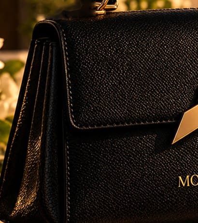 Hands finishing the edge of black leather