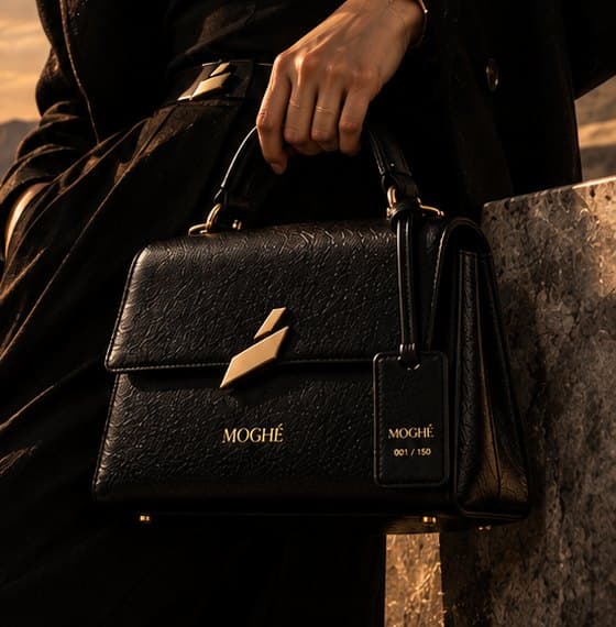 The Icon Bag carried through a black marble interior